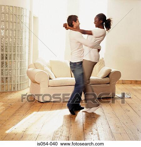 Stock Image - Couple dancing at home . Fotosearch