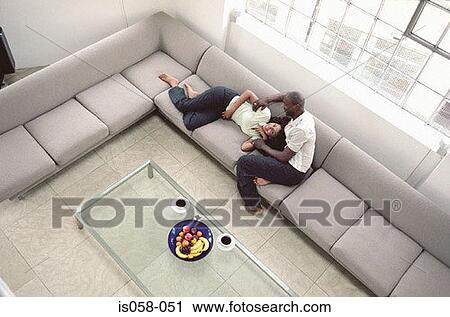 Couple on couch View Large Photo Image Stock Image - Couple on couch. Fotosearch