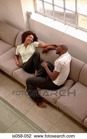 Stock Image - Couple on couch. Fotosearch