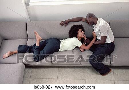 Couple on couch View Large Photo Image Stock Photo - Couple on couch. Fotosearch