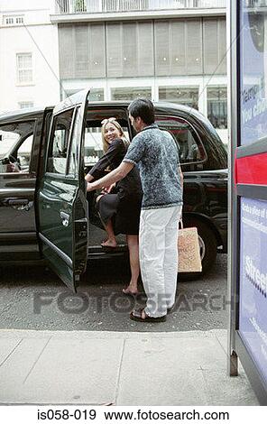 Stock Photo - Couple taking taxi. Fotosearch