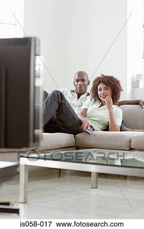 Couple watching TV View Large Photo Image Stock Photo - Couple watching TV. Fotosearch