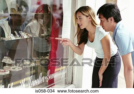 Couple window-shopping View Large Photo Image Picture - Couple window-shopping. Fotosearch