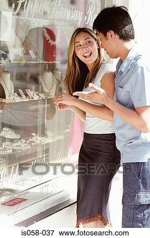 Couple window-shopping View Large Photo Image Stock Photo - Couple window-shopping. Fotosearch