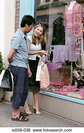 Couple window-shopping View Large Photo Image Stock Photo - Couple window-shopping. Fotosearch
