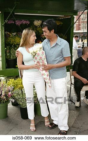 Couple with flowers View Large Photo Image Stock Photo - Couple with flowers. Fotosearch