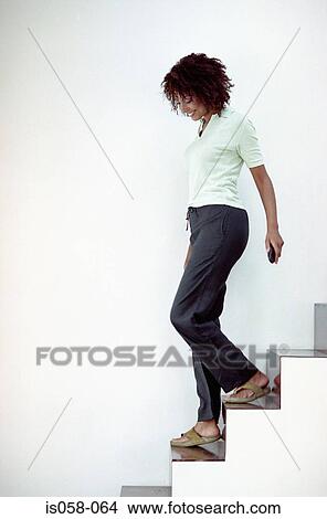 Woman descending stairs View Large Photo Image Picture - Woman descending stairs. Fotosearch