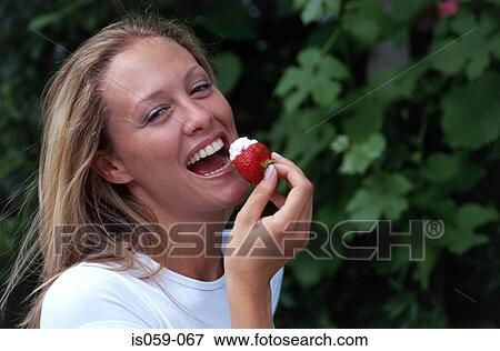 Girl eating strawberry View Large Photo Image Stock Photo - Girl eating strawberry. Fotosearch