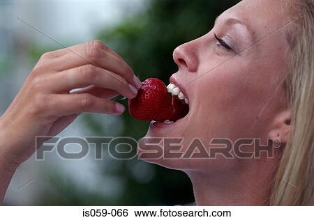 Girl eating strawberry View Large Photo Image Stock Photograph - Girl eating strawberry. Fotosearch