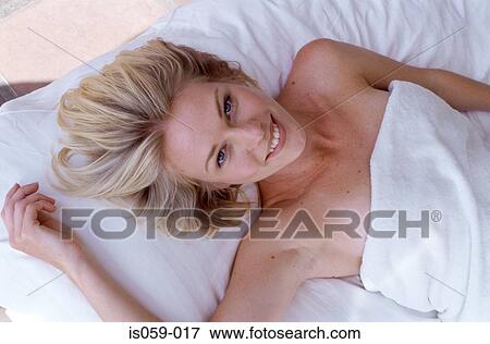 Girl lying on bed View Large Photo Image Stock Photo - Girl lying on bed. Fotosearch