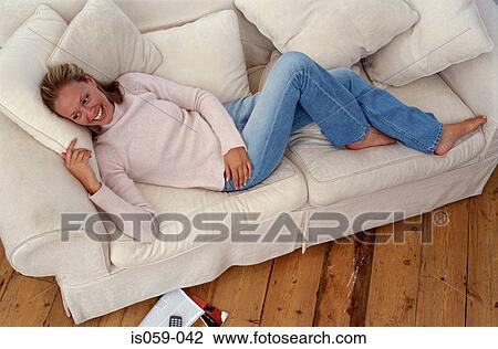 Girl lying on sofa View Large Photo Image Stock Image - Girl lying on sofa. Fotosearch