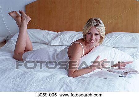 Girl reading in bed View Large Photo Image Stock Photography - Girl reading in bed. Fotosearch