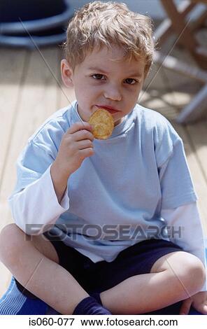 Boy eating biscuit View Large Photo Image Stock Photo - Boy eating biscuit. Fotosearch