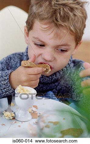 Boy eating breakfast View Large Photo Image Picture - Boy eating breakfast. Fotosearch