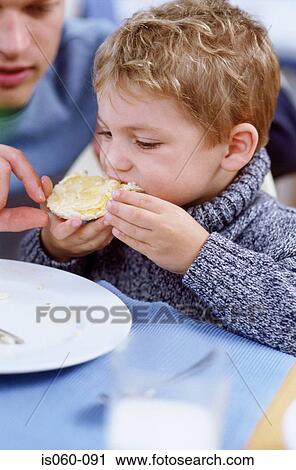 Boy eating breakfast View Large Photo Image Stock Image - Boy eating breakfast. Fotosearch