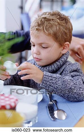 Boy peeling egg View Large Photo Image Stock Image - Boy peeling egg. Fotosearch