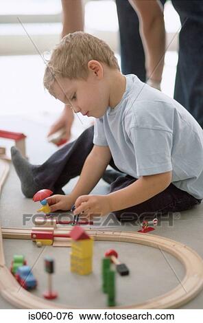 Boy playing with model railway View Large Photo Image Stock Photograph - Boy playing with model railway. Fotosearch