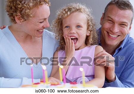 Stock Image - Family with birthday cake. Fotosearch