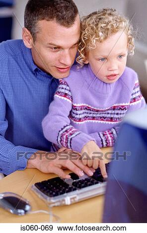 Stock Photo - Father and daughter at computer. Fotosearch