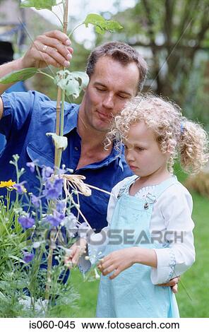 Stock Photography - Father and daughter in garden. Fotosearch