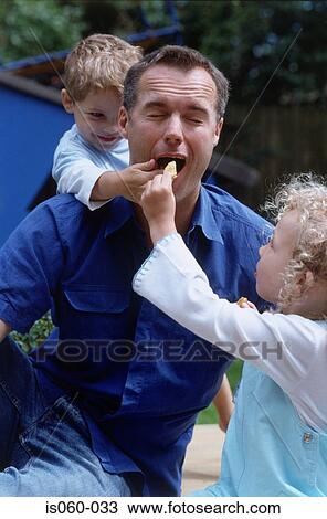 Stock Image - Father and kids outdoors. Fotosearch