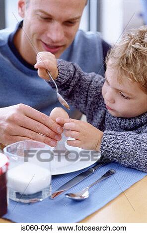 Father and son at breakfast View Large Photo Image Picture - Father and son at breakfast. Fotosearch