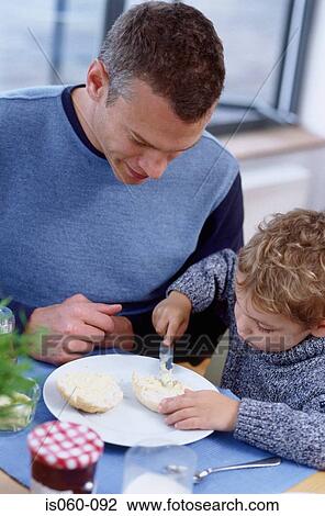 Stock Image - Father and son at breakfast. Fotosearch