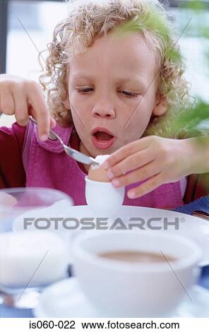 Stock Image - Girl eating breakfast. Fotosearch