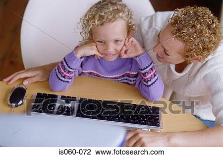 Stock Image - Mother and daughter at computer. Fotosearch