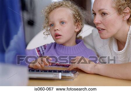 Stock Photo - Mother and daughter at computer. Fotosearch