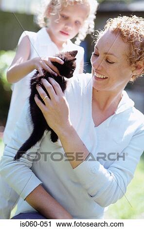 Mother and daughter with cat View Large Photo Image Stock Image - Mother and daughter with cat. Fotosearch
