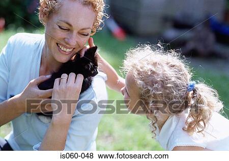 Mother and daughter with cat View Large Photo Image Stock Photo - Mother and daughter with cat. Fotosearch