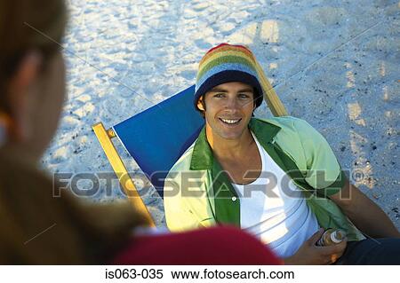 Man sitting in deck chair View Large Photo Image Stock Photography - Man sitting in deck chair. Fotosearch