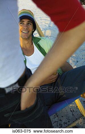 Man sitting in deck chair View Large Photo Image Stock Photography - Man sitting in deck chair. Fotosearch