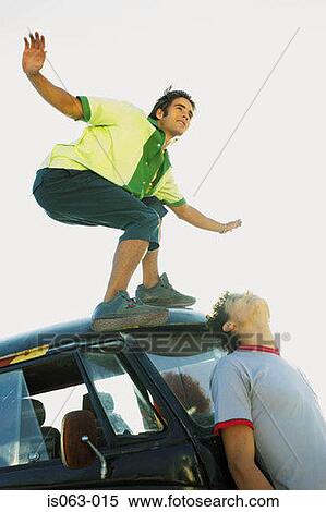 Man standing on van View Large Photo Image Stock Photography - Man standing on van. Fotosearch