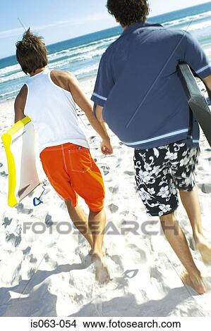 Men with boogie boards View Large Photo Image Picture - Men with boogie boards. Fotosearch