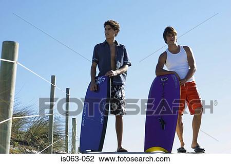 Men with boogie boards View Large Photo Image Stock Image - Men with boogie boards. Fotosearch