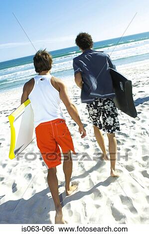 Stock Photograph - Men with boogie boards. Fotosearch