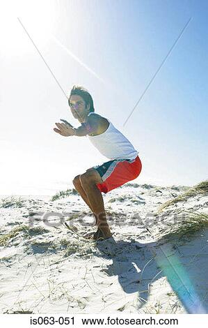 Stock Image - Surfer on beach. Fotosearch