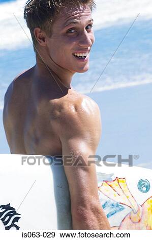 Surfer on beach View Large Photo Image Stock Photo - Surfer on beach. Fotosearch