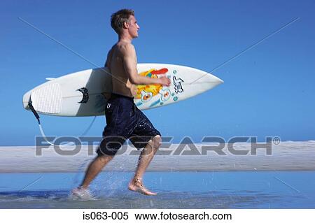 Stock Photography - Surfer running. Fotosearch