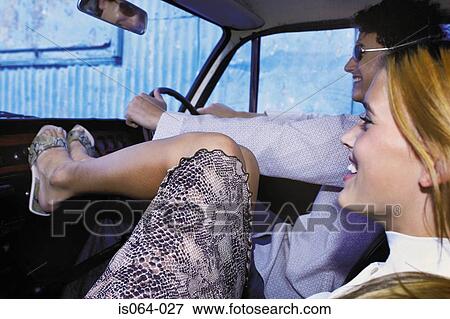 Couple driving in car View Large Photo Image Stock Photo - Couple driving in car. Fotosearch