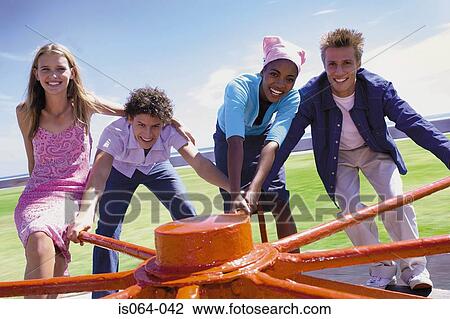 Group spinning roundabout View Large Photo Image Stock Image - Group spinning roundabout. Fotosearch