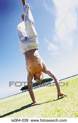 Man doing handstand View Large Photo Image Stock Photo - Man doing handstand. Fotosearch