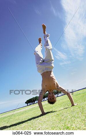 Man doing handstand View Large Photo Image Stock Photography - Man doing handstand. Fotosearch