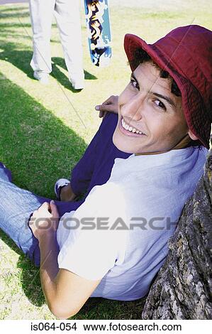 Man leaning against tree View Large Photo Image Picture - Man leaning against tree. Fotosearch