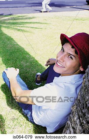 Man leaning against tree View Large Photo Image Stock Photo - Man leaning against tree. Fotosearch