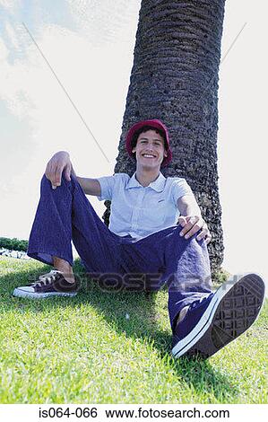 Man leaning against tree View Large Photo Image Stock Photograph - Man leaning against tree. Fotosearch