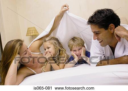 Stock Image - Family in bed. Fotosearch