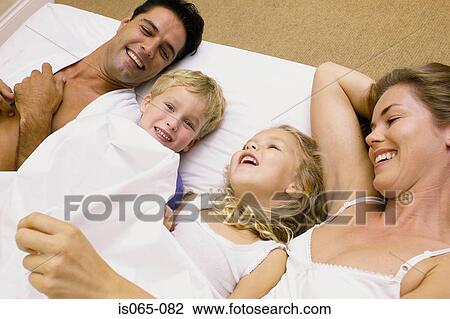 Stock Image - Family in bed. Fotosearch